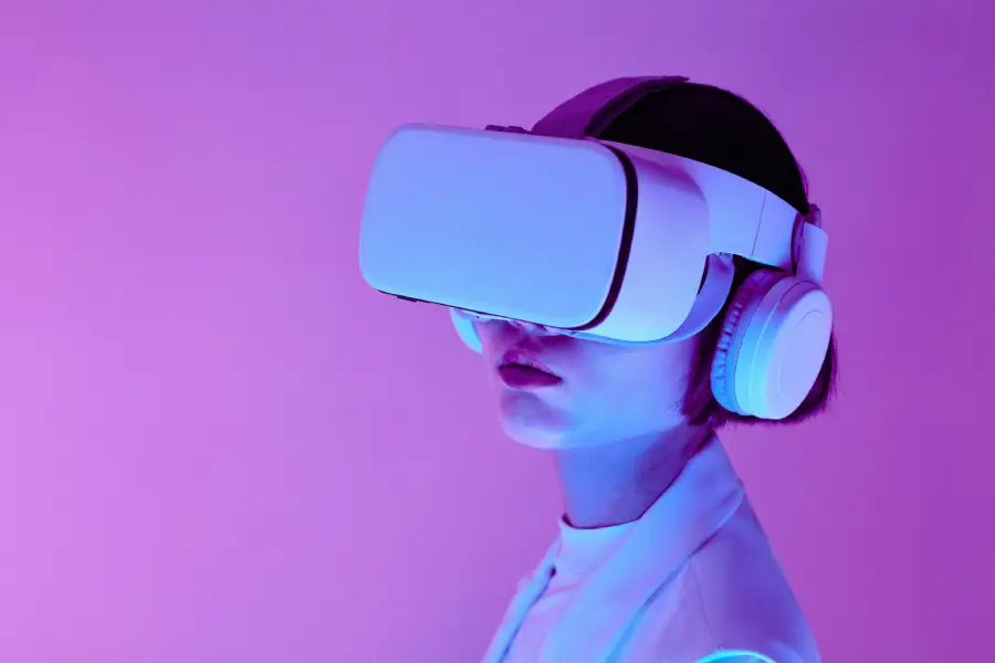 A young woman wearing a VR headset, immersed in a virtual reality experience, representing Best Love Gifts for 2025