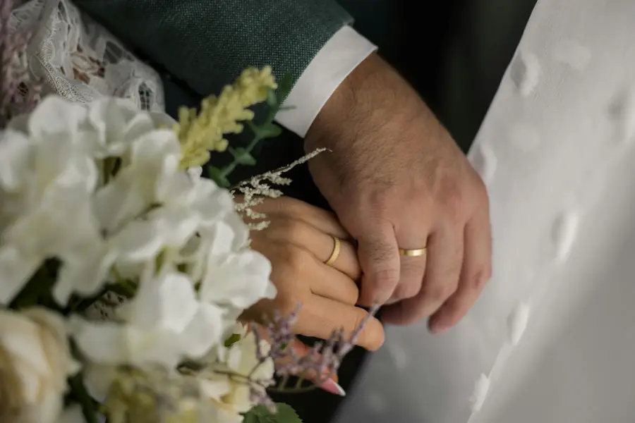 Married couple holding hands, symbolizing love and connection, exploring how to find love.