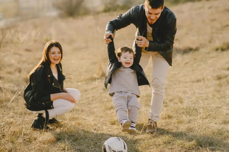 A loving couple spending quality time with their child, showcasing a strong and lasting relationship built on love, trust, and happiness.