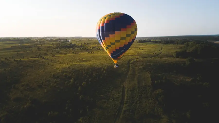 Romantic hot air balloon ride for couples at sunrise, floating above breathtaking landscapes.