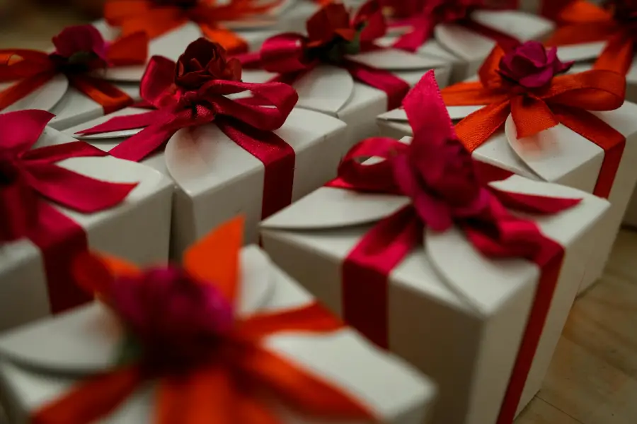 Minimalist wrapped gift boxes with simple red ribbon